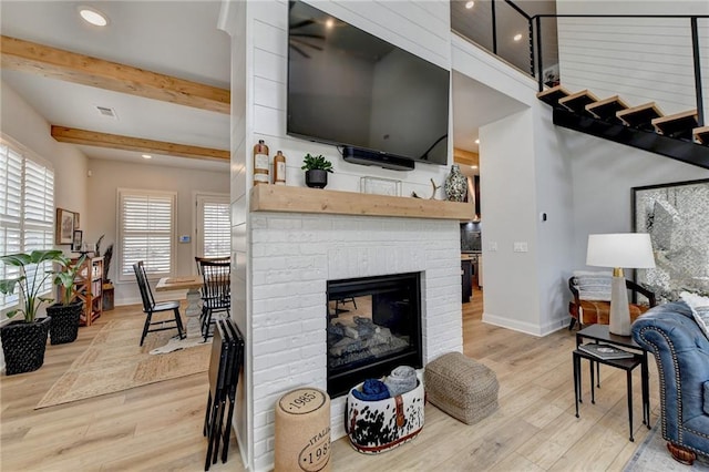 132 Swift Creek Way, Jefferson, GA 30549 - living room with a fireplace, beamed ceiling, and light wood-type flooring