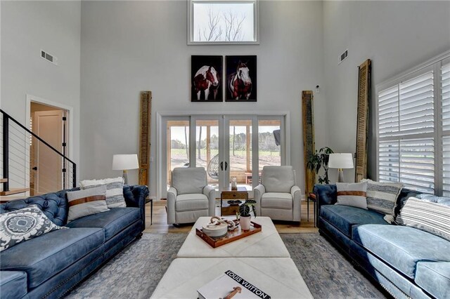 132 Swift Creek Way, Jefferson, GA 30549 - living room with french doors, a towering ceiling, and wood-type flooring