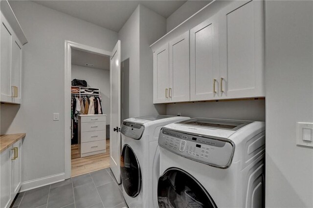 132 Swift Creek Way, Jefferson, GA 30549 - clothes washing area with cabinets, tile patterned floors, and washer and dryer