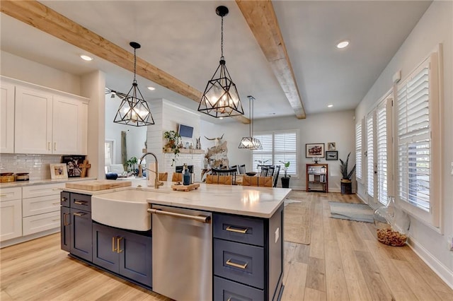132 Swift Creek Way, Jefferson, GA 30549 - kitchen featuring sink, hanging light fixtures, stainless steel dishwasher, light hardwood / wood-style floors, and white cabinetry