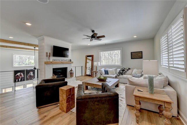 132 Swift Creek Way, Jefferson, GA 30549 - living room featuring a fireplace, a wealth of natural light, light hardwood / wood-style flooring, and ceiling fan