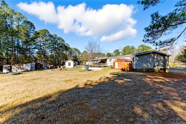 view of yard with an outbuilding and a shed