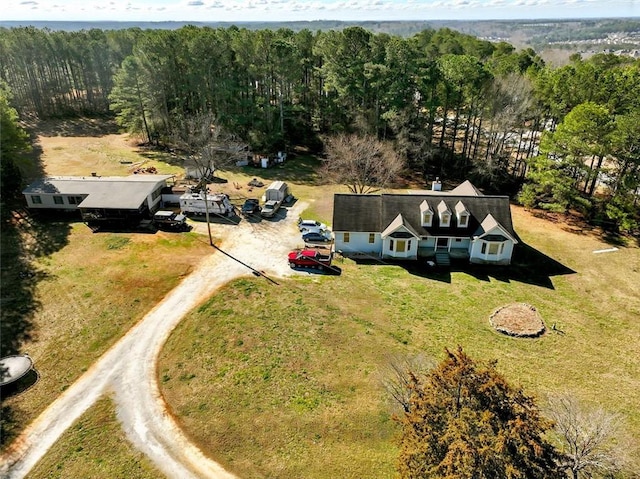 drone / aerial view featuring a forest view