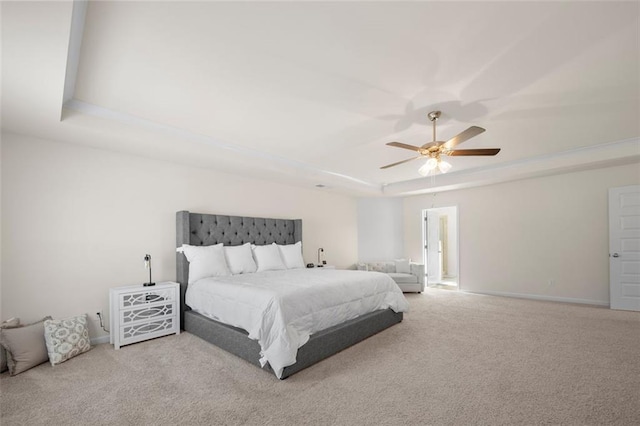 bedroom with carpet floors, a tray ceiling, a ceiling fan, and baseboards