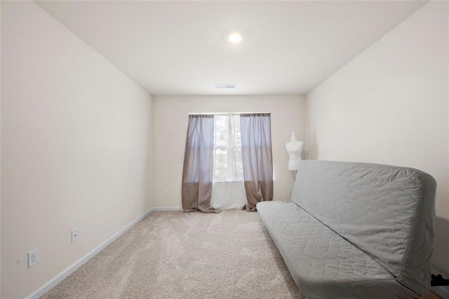 living area featuring carpet floors, visible vents, and baseboards