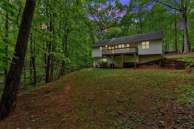 rear view of property featuring a wooden deck