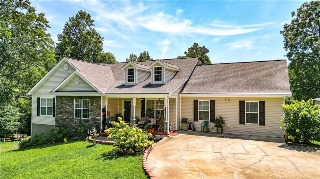 cape cod house with a front lawn and a porch