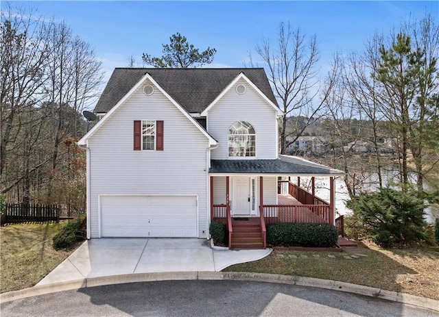 view of front of home featuring a garage, covered porch, roof with shingles, and driveway