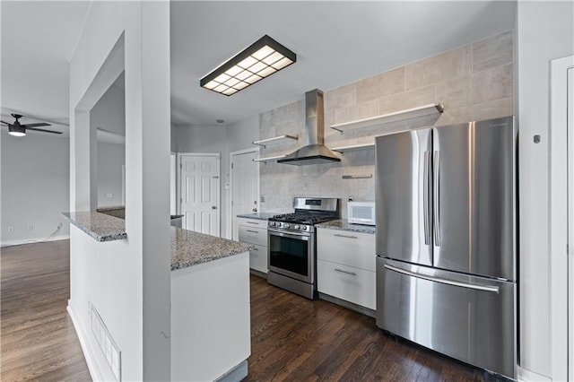 kitchen with exhaust hood, white cabinets, appliances with stainless steel finishes, light stone countertops, and open shelves