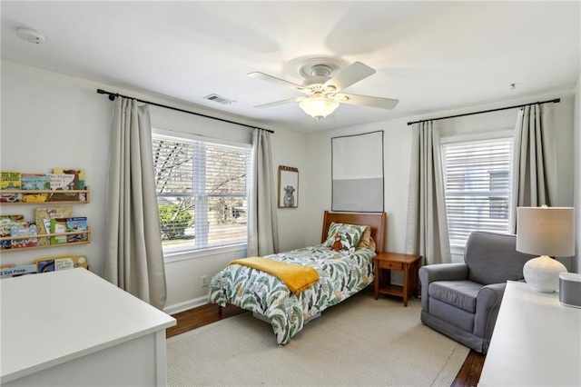 bedroom with visible vents, baseboards, and ceiling fan