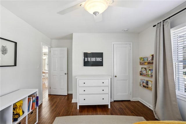 bedroom with ceiling fan, baseboards, and dark wood-style floors