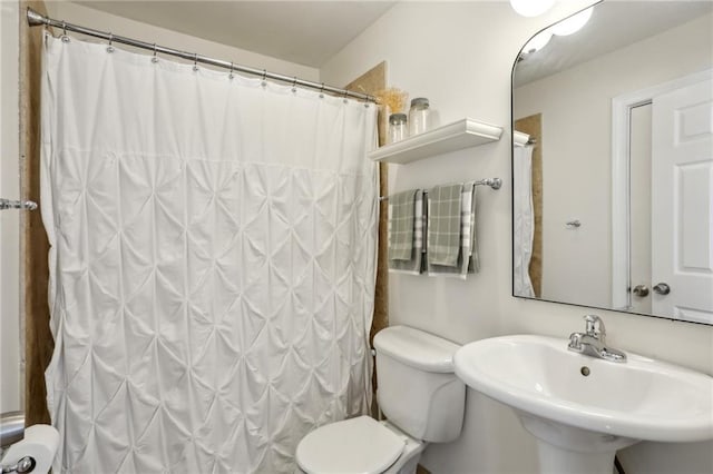 full bathroom with a sink, toilet, and a shower with shower curtain