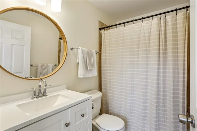 bathroom with toilet and vanity