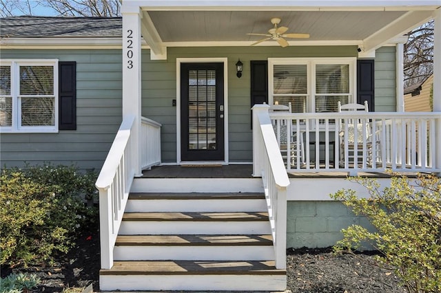 entrance to property featuring a porch and ceiling fan