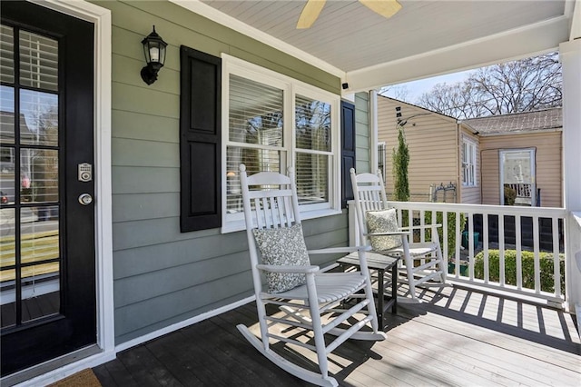 wooden terrace with a porch and ceiling fan