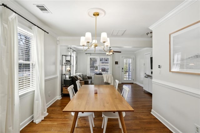 dining area featuring a chandelier, visible vents, ornamental molding, and wood finished floors