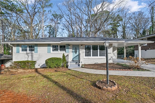 ranch-style home with a carport and a front yard