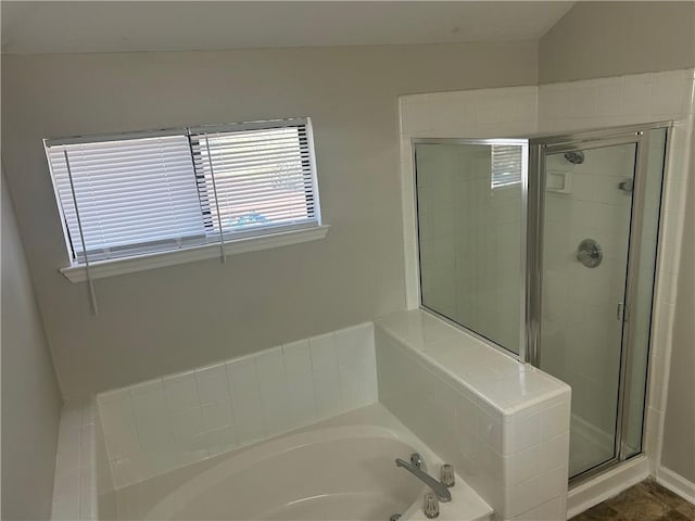 bathroom with a shower stall and a garden tub