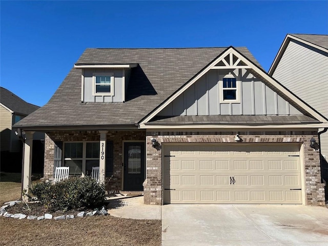 view of front of home with a garage, driveway, a porch, and board and batten siding