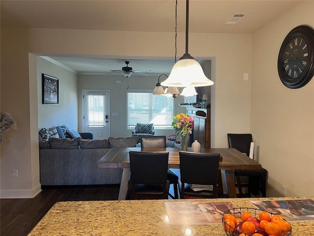 dining area featuring baseboards, visible vents, ceiling fan, and dark wood-style flooring