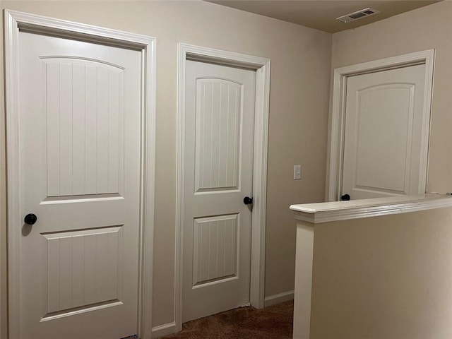 interior space with carpet floors and visible vents