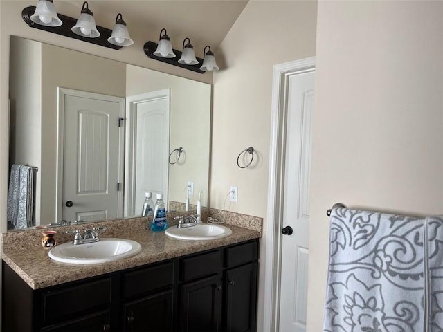 bathroom featuring a sink and double vanity