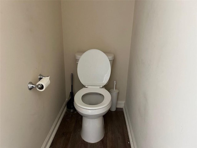 bathroom featuring toilet, baseboards, and wood finished floors