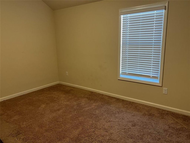 carpeted empty room with baseboards