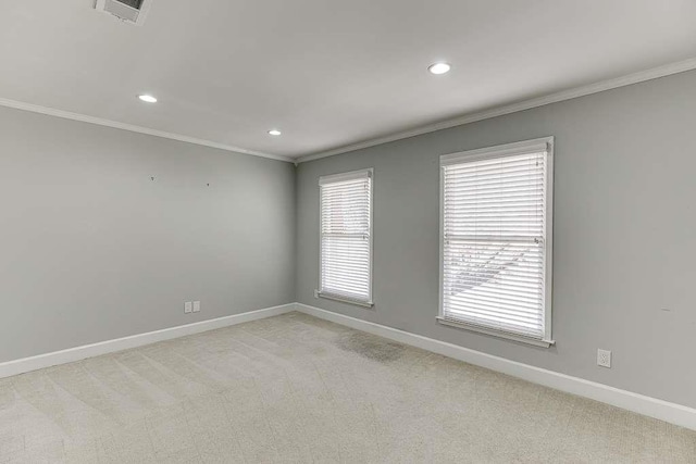 unfurnished room featuring baseboards, light colored carpet, and visible vents