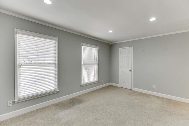 spare room featuring carpet floors, ornamental molding, baseboards, and recessed lighting