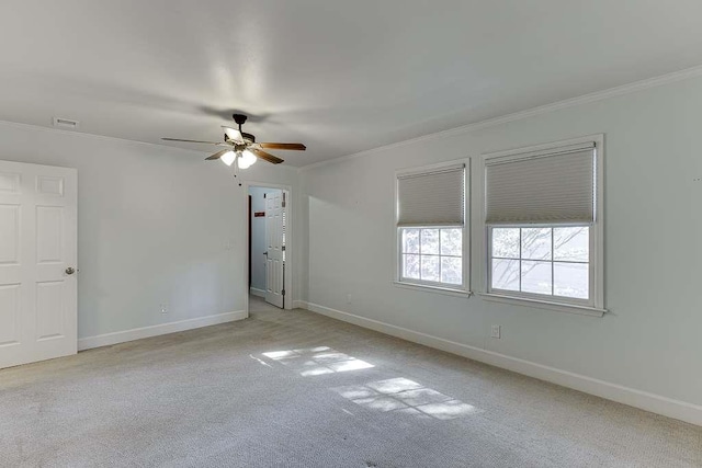 unfurnished room with baseboards, carpet flooring, and crown molding