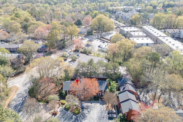 birds eye view of property featuring a view of trees