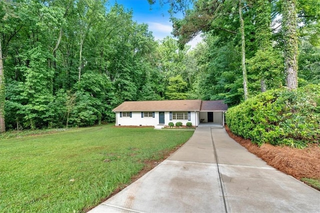 5689 Woodland Dr, Acworth, GA 30102 - single story home featuring concrete driveway, a front yard, a view of trees, and an attached carport