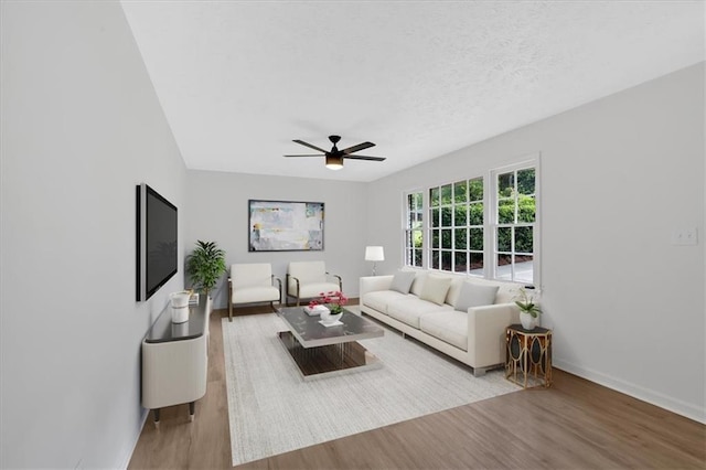 5689 Woodland Dr, Acworth, GA 30102 - living room with wood finished floors, ceiling fan, baseboards, and a textured ceiling