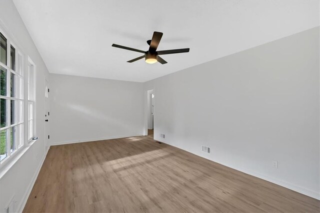 5689 Woodland Dr, Acworth, GA 30102 - spare room with wood finished floors, ceiling fan, and baseboards