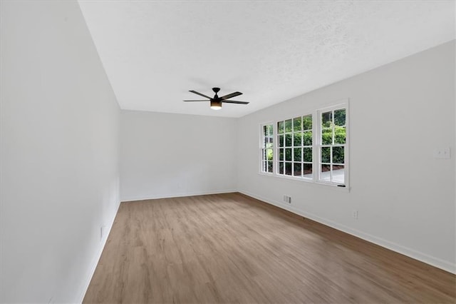5689 Woodland Dr, Acworth, GA 30102 - spare room with wood finished floors, ceiling fan, and baseboards
