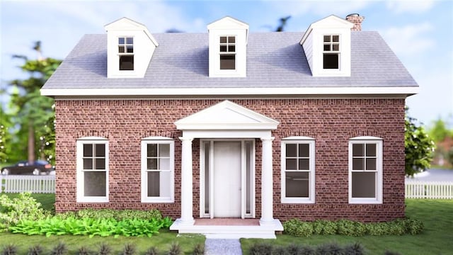view of front of house with a chimney, brick siding, and fence