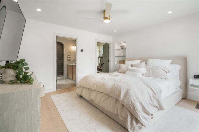 bedroom with light wood finished floors, recessed lighting, a ceiling fan, and ensuite bathroom