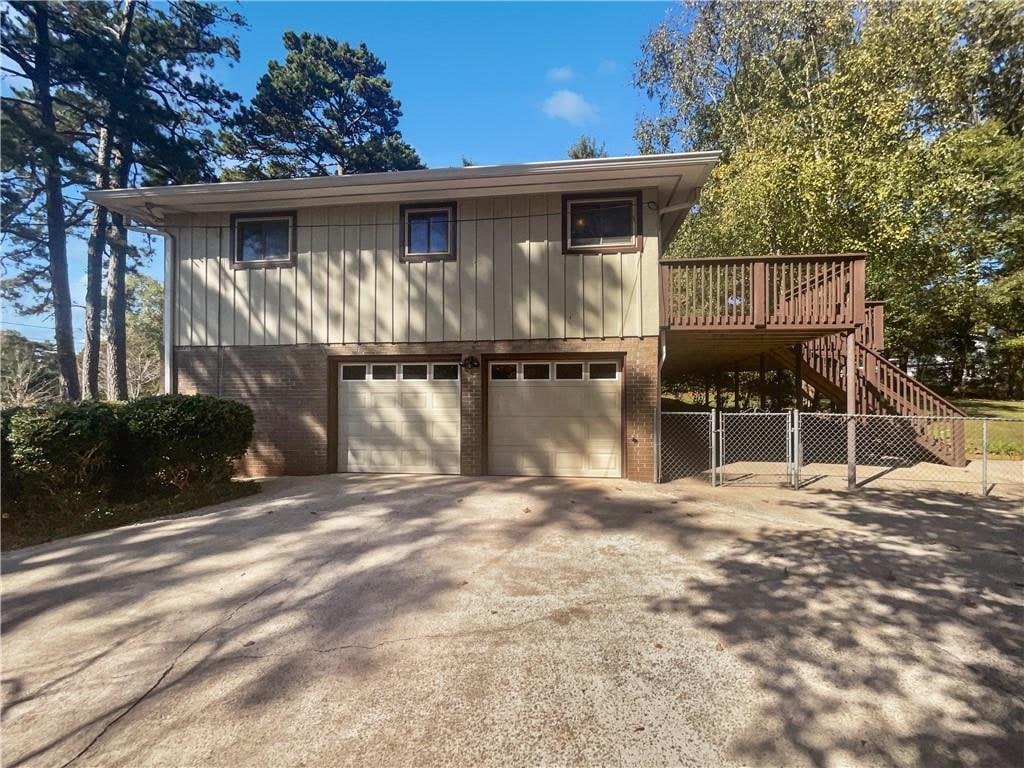 view of property featuring a wooden deck and a garage