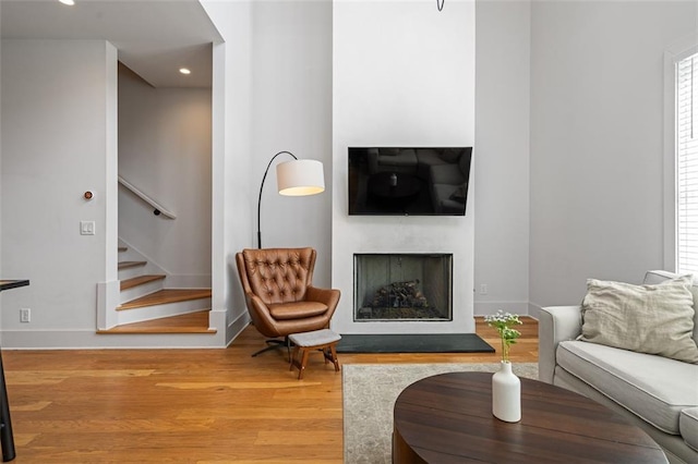 155 Breakspear Ln, Fayetteville, GA 30214 - living area with wood finished floors, stairs, a fireplace with raised hearth, recessed lighting, and baseboards