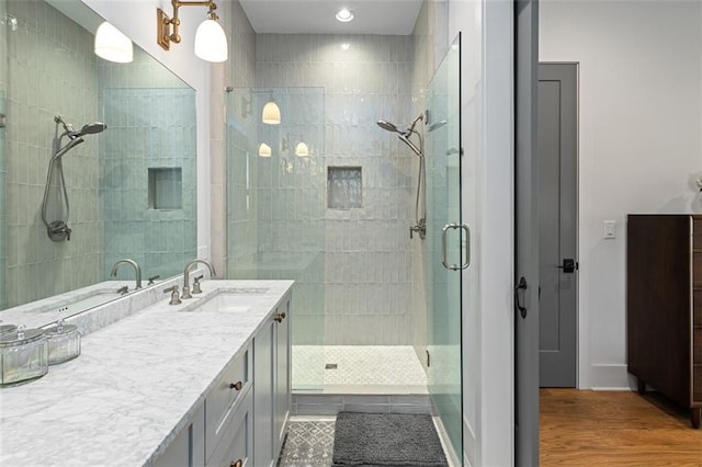 155 Breakspear Ln, Fayetteville, GA 30214 - bathroom featuring a tile shower, double vanity, and wood finished floors
