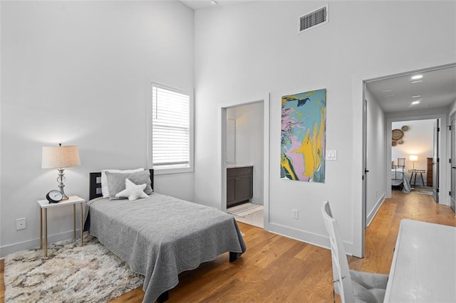 155 Breakspear Ln, Fayetteville, GA 30214 - bedroom featuring light wood-style floors, a high ceiling, baseboards, and ensuite bath
