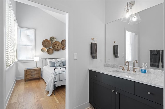 155 Breakspear Ln, Fayetteville, GA 30214 - ensuite bathroom with wood finished floors, vanity, healthy amount of natural light, and baseboards