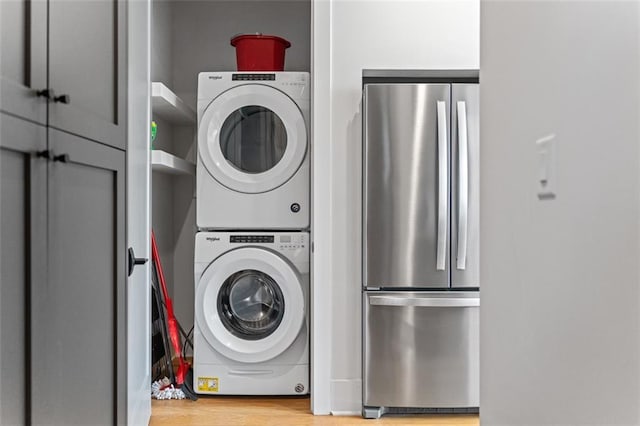 155 Breakspear Ln, Fayetteville, GA 30214 - laundry room featuring stacked washer and clothes dryer and light wood-type flooring
