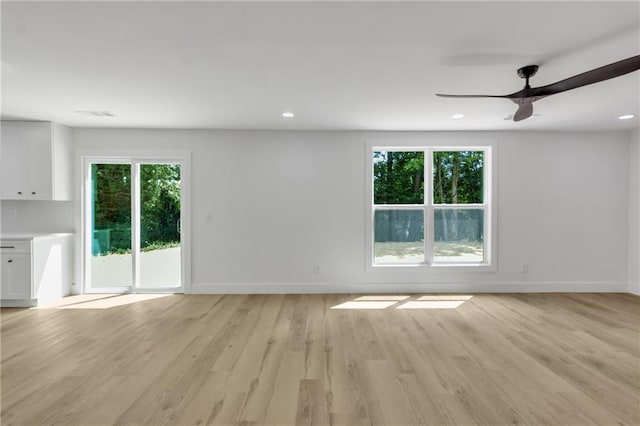 2601 Garland Way, Duluth, GA 30096 - unfurnished living room with healthy amount of natural light, baseboards, light wood-style flooring, a ceiling fan, and recessed lighting