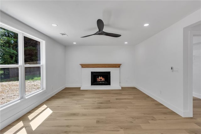 2601 Garland Way, Duluth, GA 30096 - unfurnished living room featuring plenty of natural light, a ceiling fan, recessed lighting, a lit fireplace, and light wood-type flooring