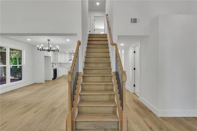 2601 Garland Way, Duluth, GA 30096 - staircase featuring wood finished floors, recessed lighting, baseboards, and a chandelier