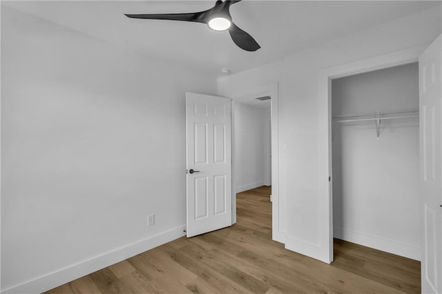 2601 Garland Way, Duluth, GA 30096 - unfurnished bedroom with a closet, baseboards, wood finished floors, and ceiling fan