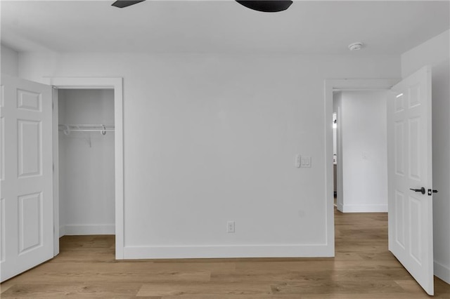 2601 Garland Way, Duluth, GA 30096 - unfurnished bedroom featuring baseboards, a closet, light wood-type flooring, and a walk in closet