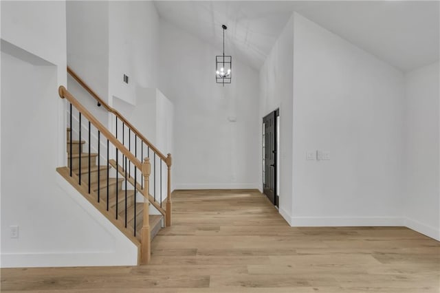 2601 Garland Way, Duluth, GA 30096 - entryway featuring high vaulted ceiling, stairs, light wood-style flooring, a chandelier, and baseboards